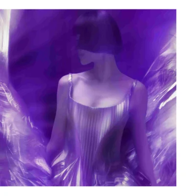 Purple-toned image of a person with short dark hair in a shiny pleated dress surrounded by reflective material.