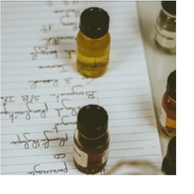 A close-up shows small glass vials of amber and yellow liquid on a lined notebook page with handwritten notes including 3 Rused, Bergamot S/B TR, plum & Rilygn, CD, and Paronnya.