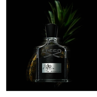 A dark brown perfume bottle with a gold cap is surrounded by swirling white smoke against a black background, displaying the words CREED, a gold crest, and OUD ZARIAN on its front.