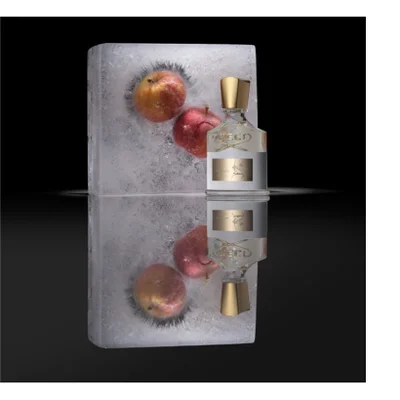 Five luxury bath and body products, including a gold hand cream tube, a black perfume bottle, two cream pump bottles, and a round cream soap bar, are displayed on a black background with golden liquid splashing around them, showing the text Creed 1760 Aventus Hand Cream Crème Mains, Creed Aventus, Creed 1760 Aventus Hand & Body Lotion Lotion Mains et Corps, Creed 1760 Aventus Hand & Body Wash Lavant Mains et Corps, and Creed 1760.