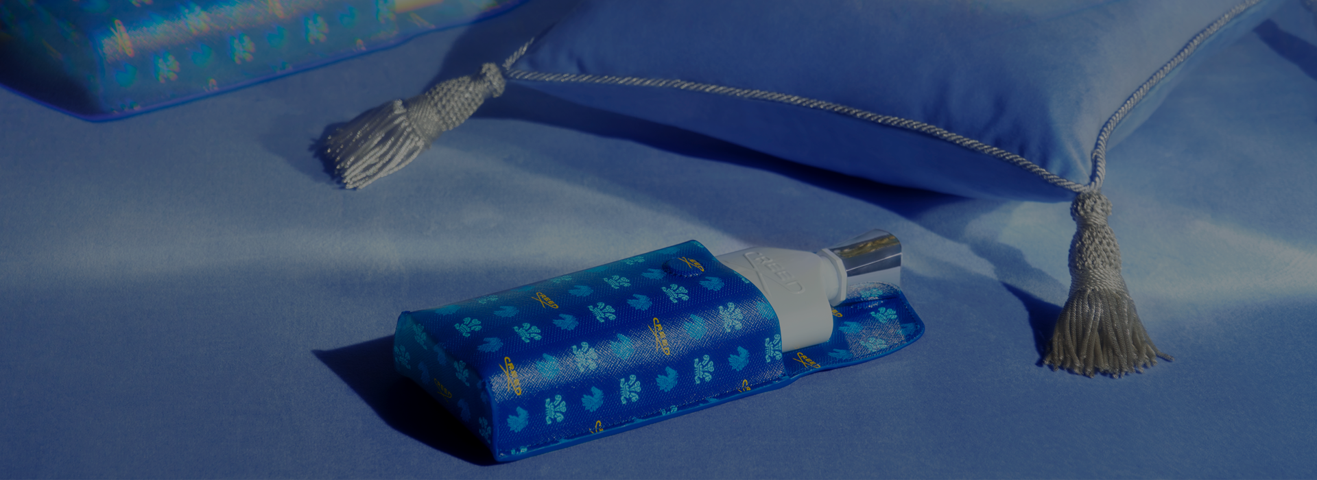 Silver Mountain in Leather Fragrance Sleeve next to cushion